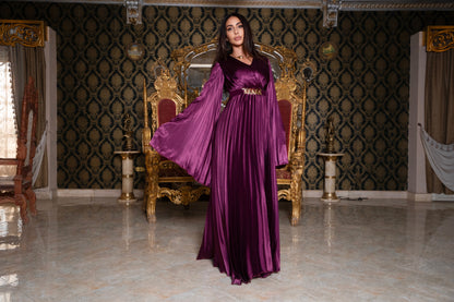 Burgundy pleated jumpsuit with gold chain belt with sleeves