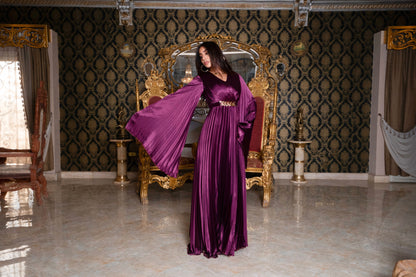 Burgundy pleated jumpsuit with gold chain belt with sleeves