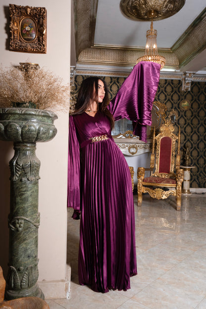 Burgundy pleated jumpsuit with gold chain belt with sleeves